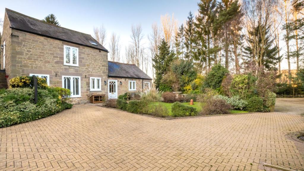 a brick house with a driveway in front of it at Frogmore Cottage in Two Dales