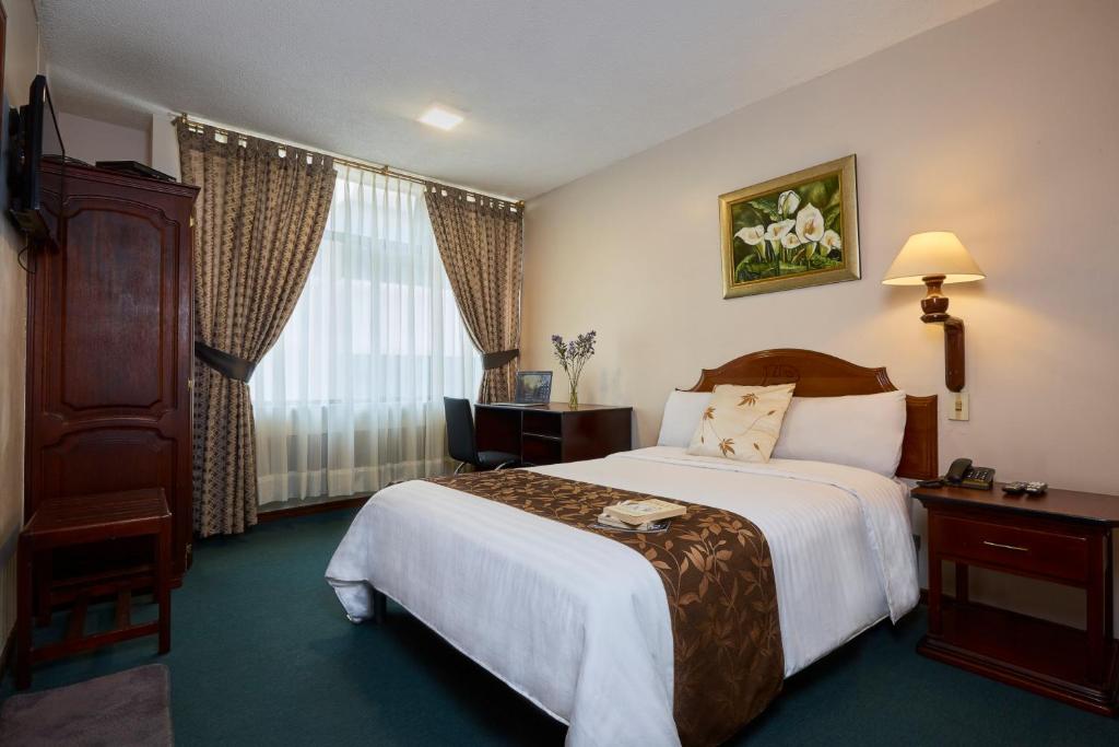 Postel nebo postele na pokoji v ubytování Hotel Podocarpus