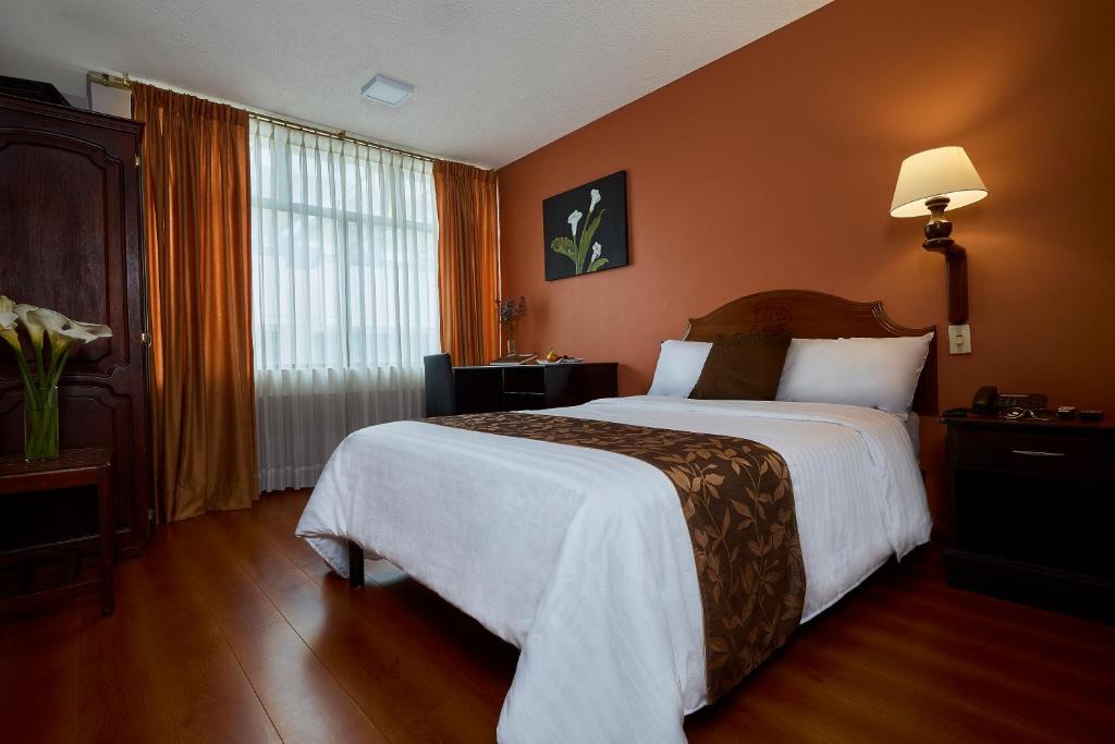 Postel nebo postele na pokoji v ubytování Hotel Podocarpus