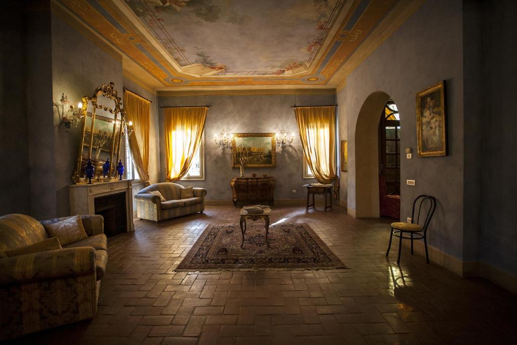 a living room with a couch and a table at R&B Villa Tartaruga in Castelfranco Emilia