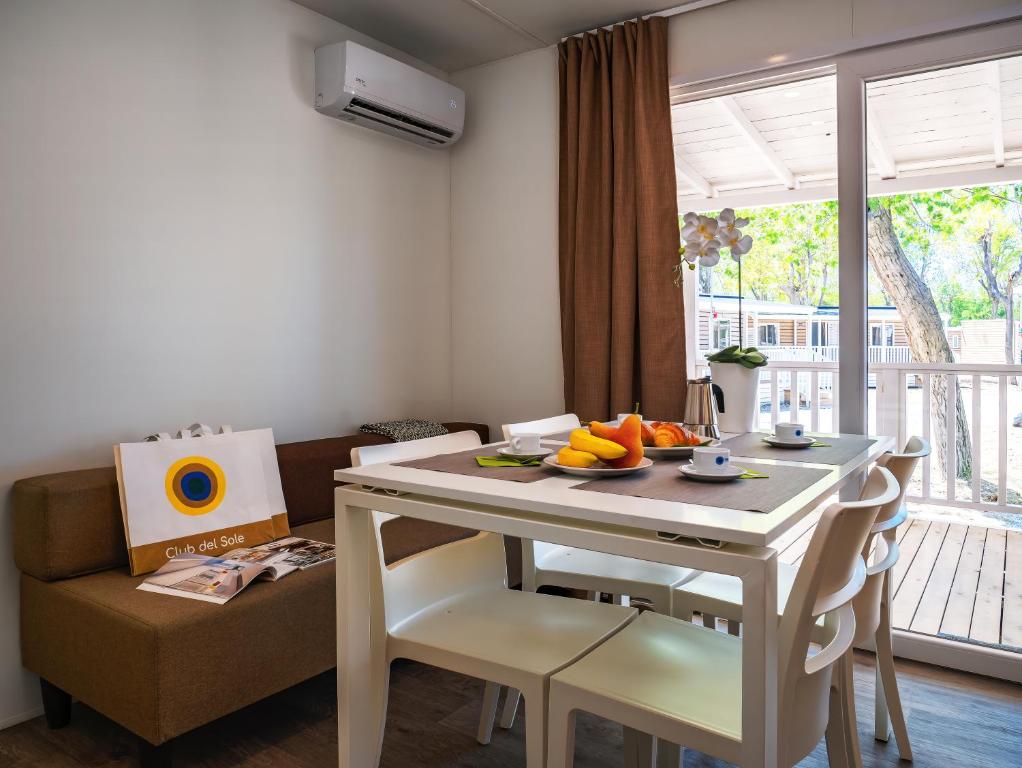 a room with a table with fruit on it at Club del Sole Rimini Family Resort in Rimini