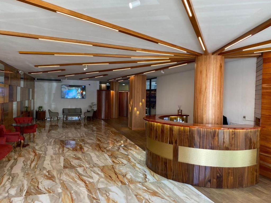 a lobby with a stone floor and a bar at Murex Plaza Hotel & Suites in Monrovia