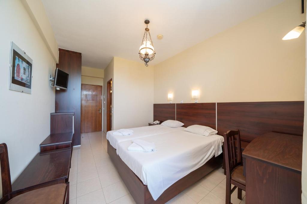 Postel nebo postele na pokoji v ubytování Lorenzo Hotel