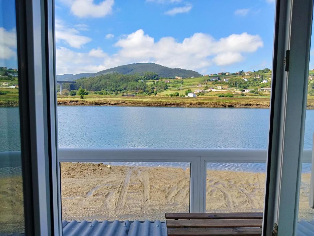 a view of a lake from a window at Apartamento Ría Navia in Navia