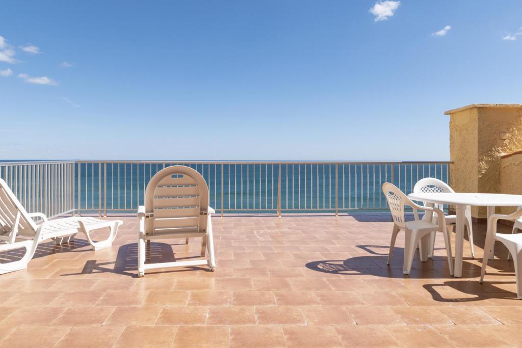 a group of chairs and tables on a patio at Pleno Sol, 45 in Cullera