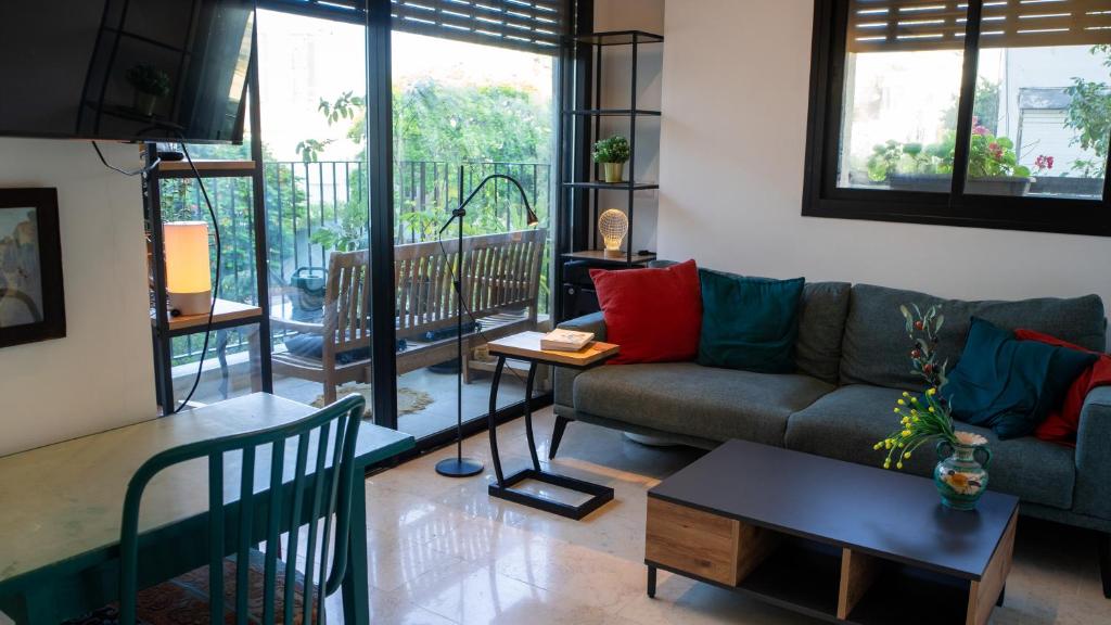 a living room with a couch and a table at Lovely 1-bedroom apartment in The best location in Tel Aviv