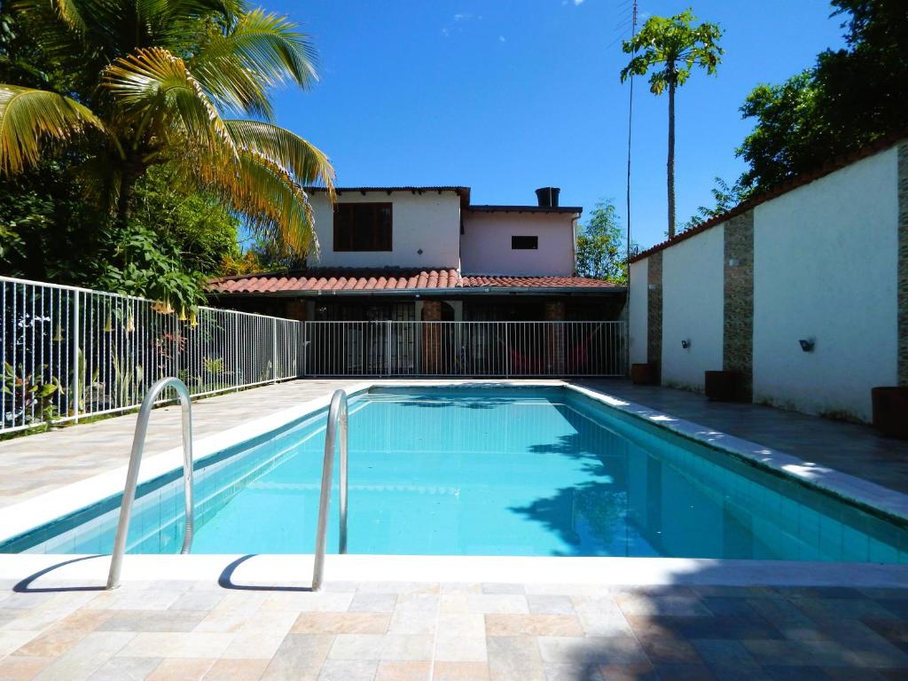 a swimming pool in front of a house at B&B Villa CALASAN in Garzón