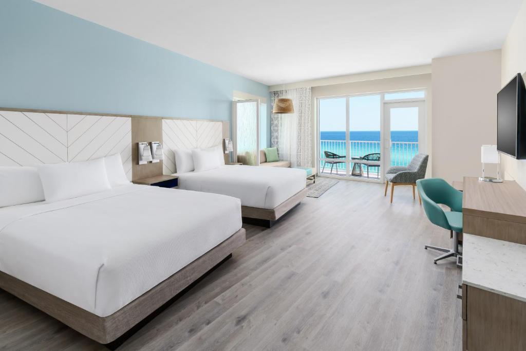a hotel room with two beds and a view of the ocean at Hyatt Place Panama City Beach - Beachfront in Panama City Beach