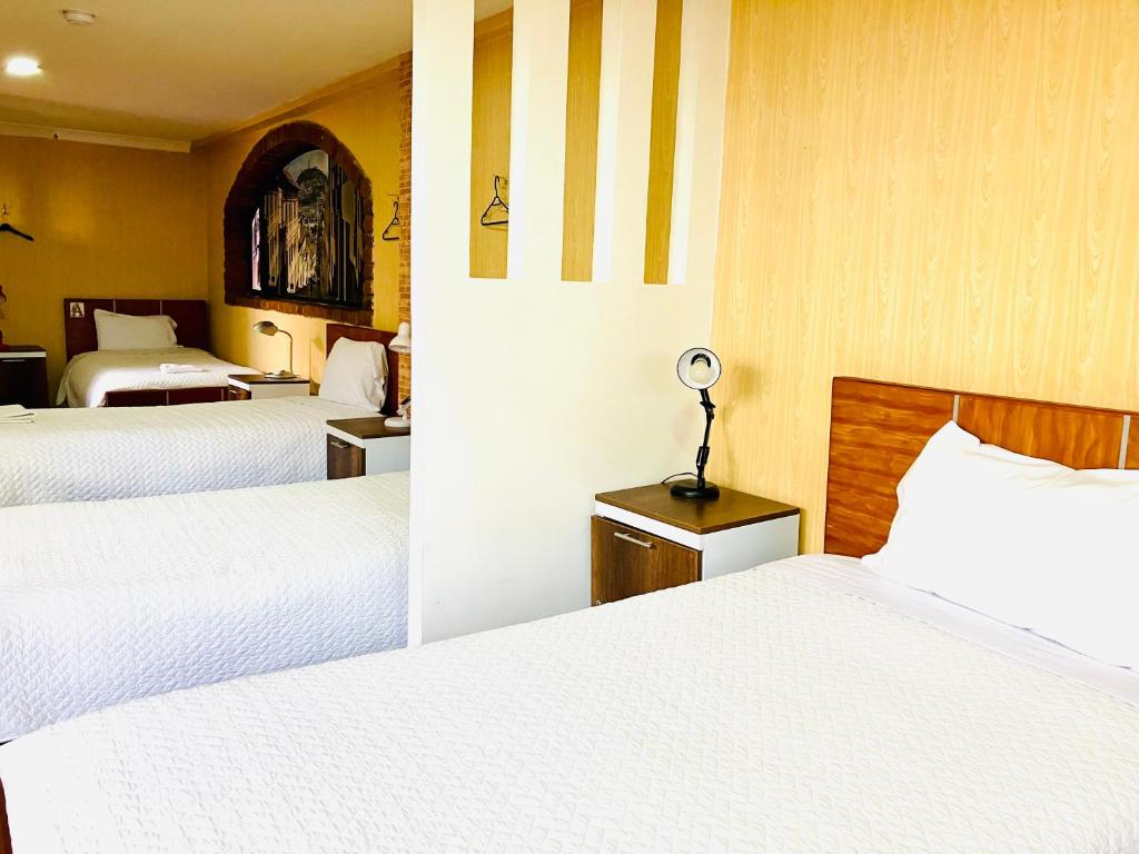 Postel nebo postele na pokoji v ubytování Quito Terrace