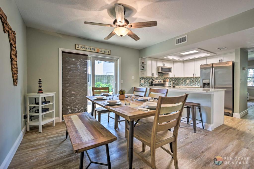 a dining room with a table and a ceiling fan at Beachside Getaway with Private Fenced Yard & Fire Pit STEPS from Flagler Avenue! in New Smyrna Beach