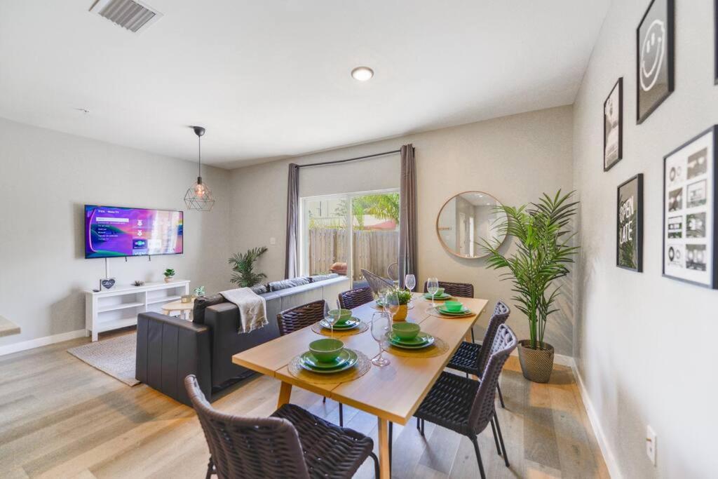 a dining room and living room with a table and chairs at Fantastic Townhouse 15minutes from the Beach in Miami