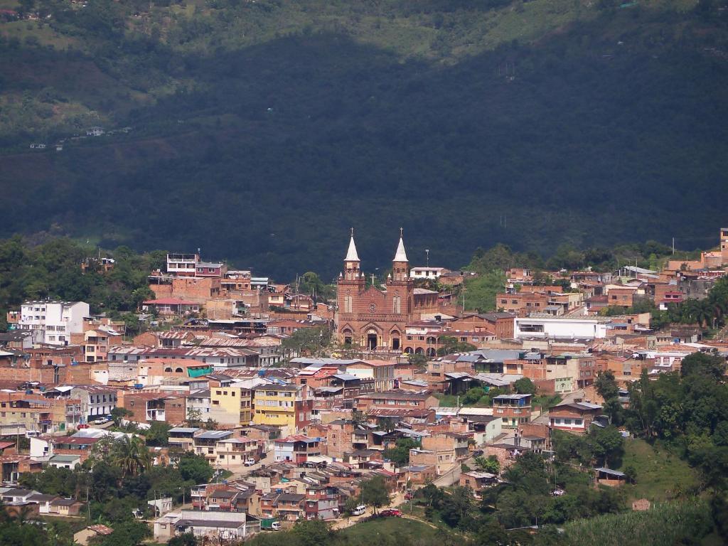 a view of a town on a mountain at Casa Hotel León in Arbeláez