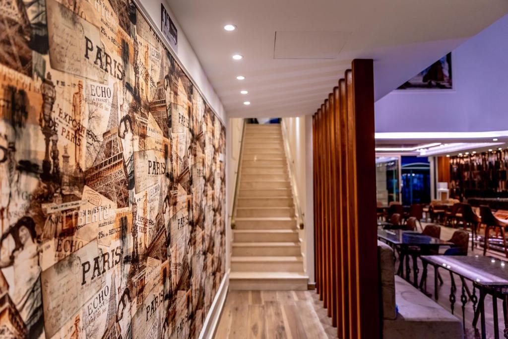 a hallway with a wall of photos on the wall of a restaurant at Leonardo Boutique Hotel Larnaca in Larnaca
