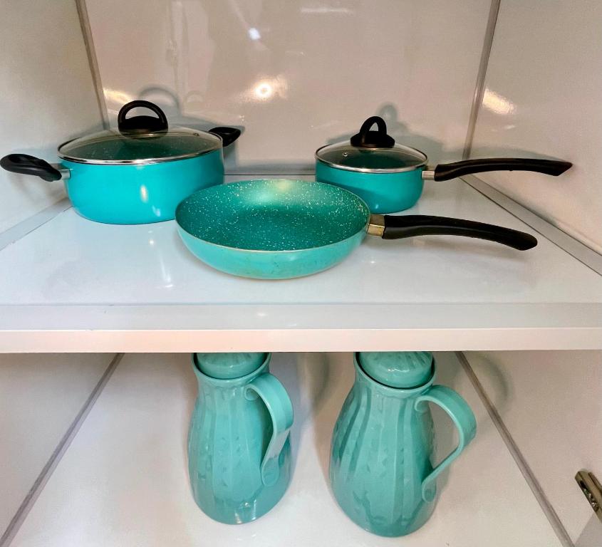 three blue pots and pans sitting on a shelf at فلامينجو Flamingo in Abha