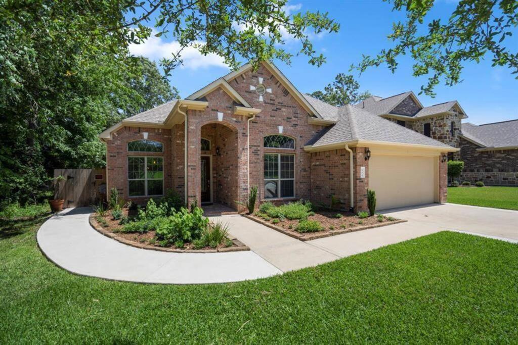 a brick house with a driveway at Spacious Conroe Home around 4 miles to the Lake in Montgomery