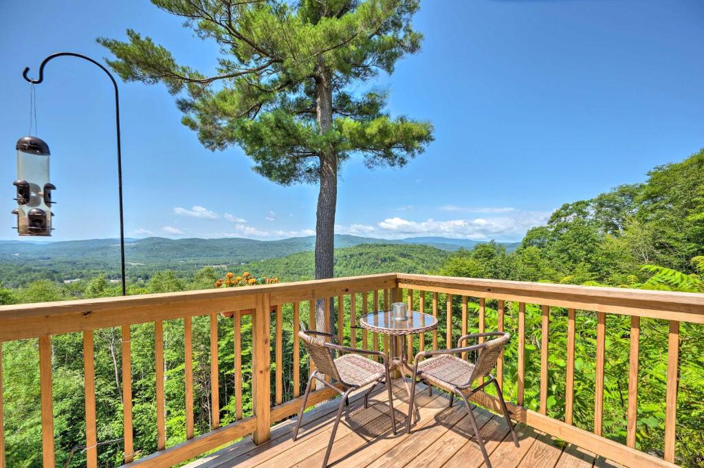 a table and chairs on a deck with a view at Campton Retreat with Mtn Views about 3 Mi to Skiing in Campton