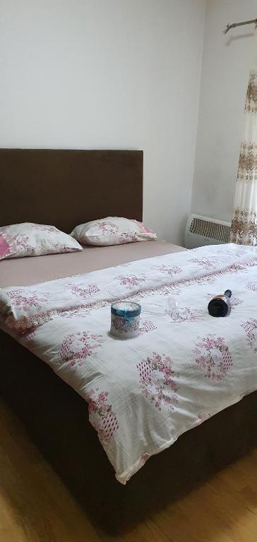 a bed with a blanket with a bowl on it at Stan na dan Bijelo Polje in Bijelo Polje