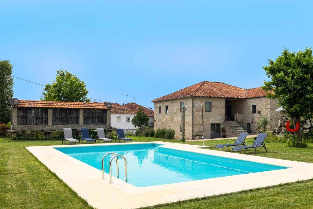 a swimming pool in the backyard of a house at Casa da Veiga in Monção