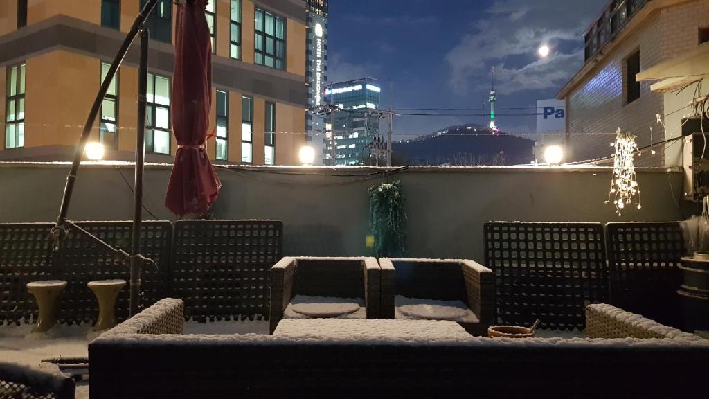 a group of benches covered in snow at night at Hangeul Guesthouse in Seoul