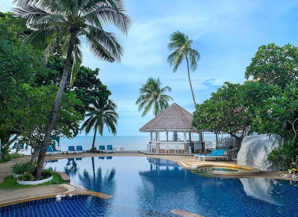 a pool at a resort with palm trees and a gazebo at Sand Sea Resort & Spa - Lamai Beach , Koh Samui in Lamai