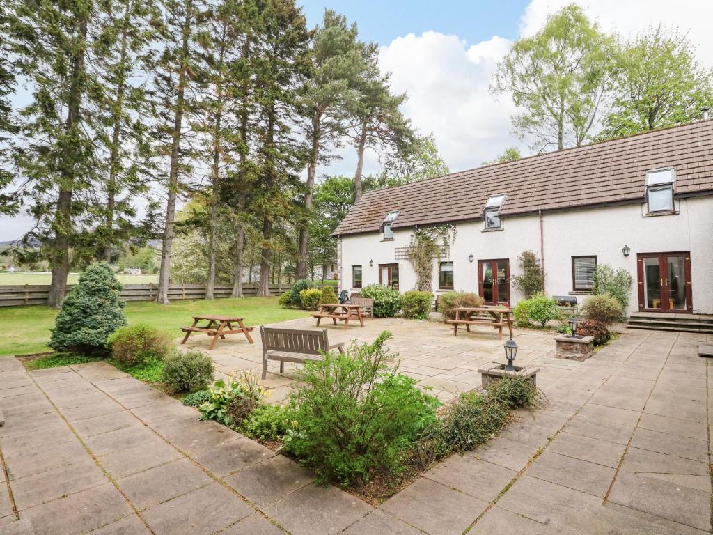 a garden with benches and a building at The Shieling in Newtonmore