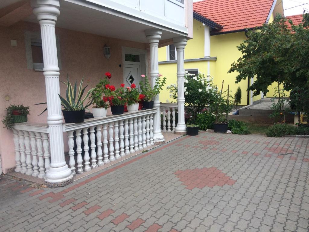 a house with potted plants on a porch at Miki in Sarajevo