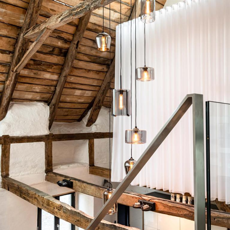 a staircase in a room with wooden ceilings at MAISON de la Bonne Vie in Thérondels