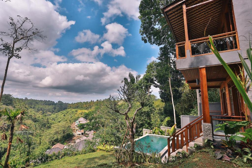 a house on the side of a hill with a pool at Bali Ubud Villa View in Ubud