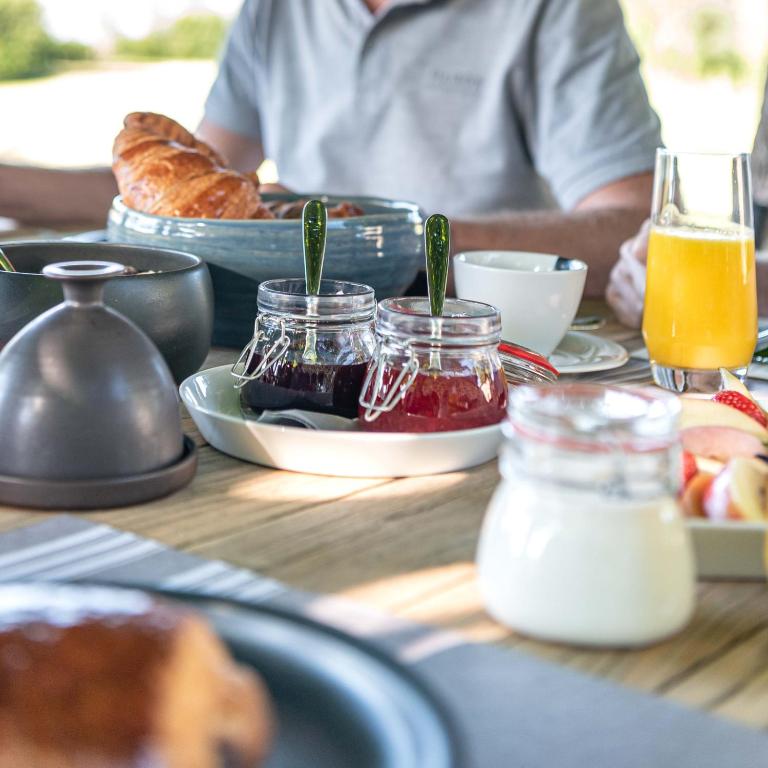 a table with a plate of food on a table at MAISON de la Bonne Vie in Thérondels