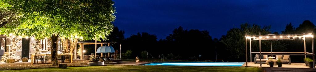a house with a swimming pool at night at MAISON de la Bonne Vie in Thérondels