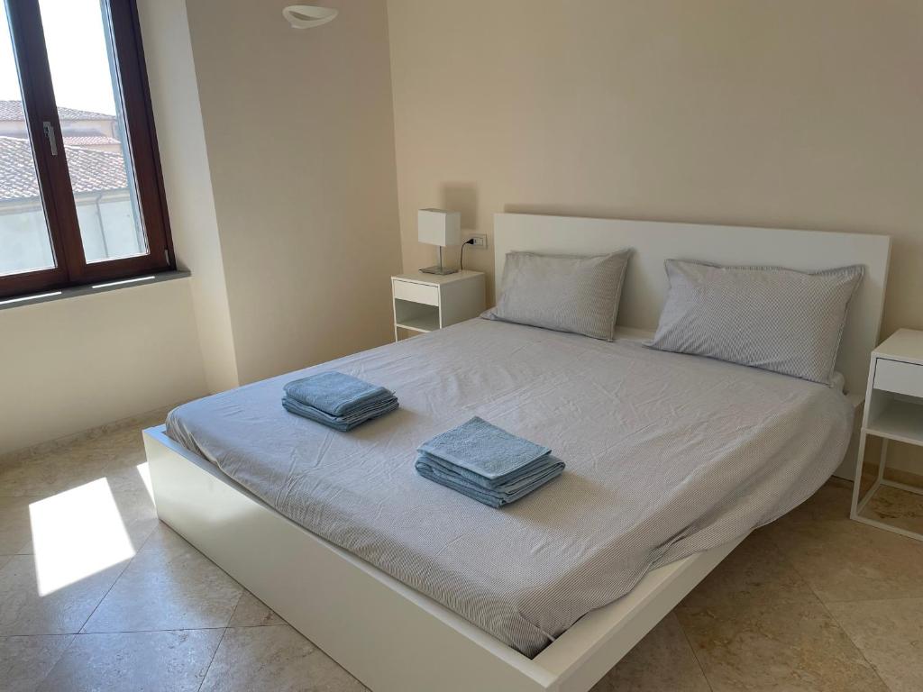 Posteľ alebo postele v izbe v ubytovaní GoldenTuscany Apartment