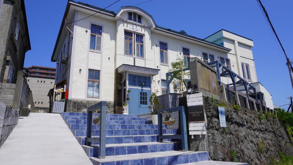 a building with blue stairs in front of a building at Little Barrel in Otaru