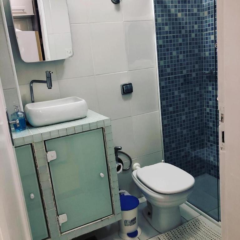 a bathroom with a toilet and a sink and a shower at Pérola de Santos House in Santos