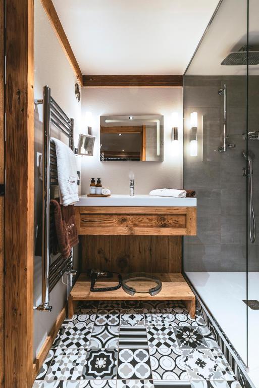 a bathroom with a sink and a shower at Hôtel Les Peupliers in Courchevel