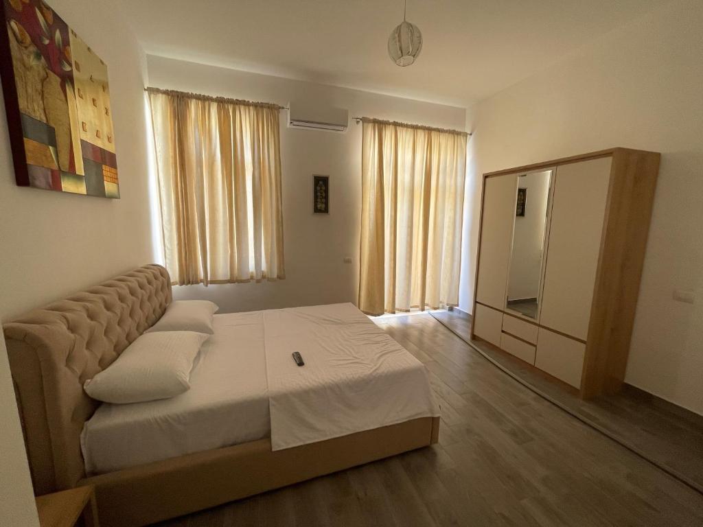 a living room with a bed and a couch at Westwood 2Bd Apartments in Durrës