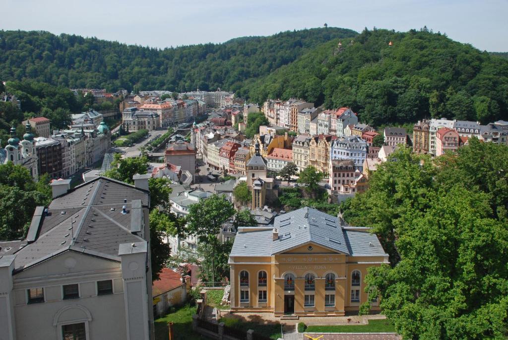a large building with a clock tower on top of it at Villa Rosa in Karlovy Vary