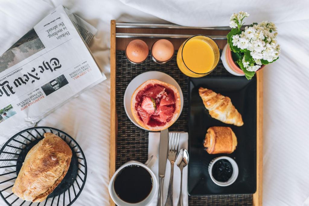 a tray of food with eggs and bread and coffee at Hôtel Les Peupliers in Courchevel