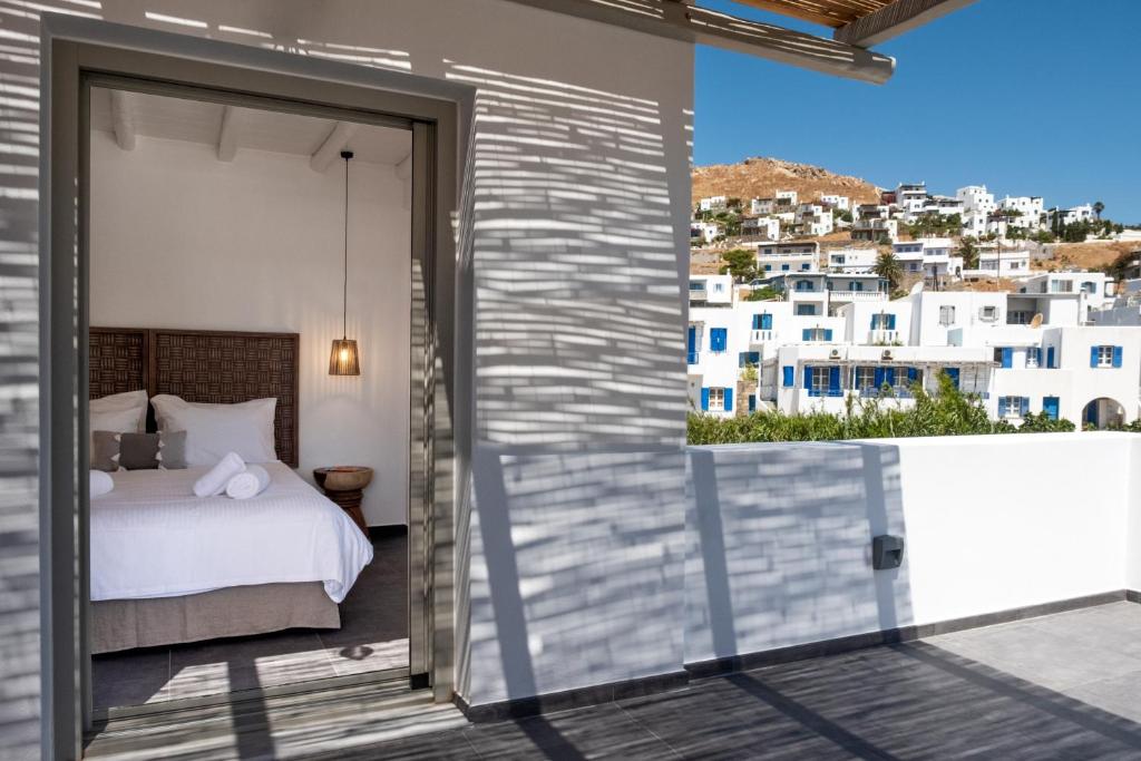 a bedroom with a bed and a view of a city at Nautilus Serifos in Livadakia