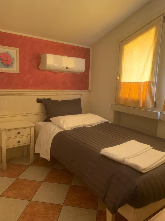 Postel nebo postele na pokoji v ubytování Hotel Due Colonne