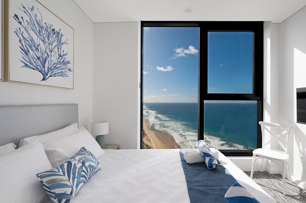 a bedroom with a bed and a view of the ocean at Sea view Beachfront apartment in surfers in Gold Coast