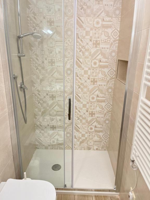 a shower with a glass door in a bathroom at Principe Amedeo in Trani