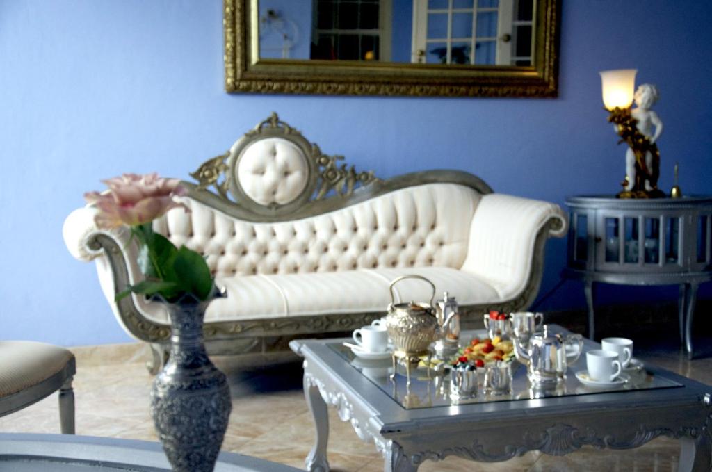 a living room with a white couch and a table at The Angels Place Boutique Guest House in Pretoria