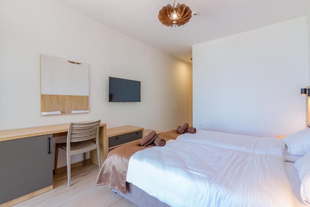 Postel nebo postele na pokoji v ubytování Lago Hotel
