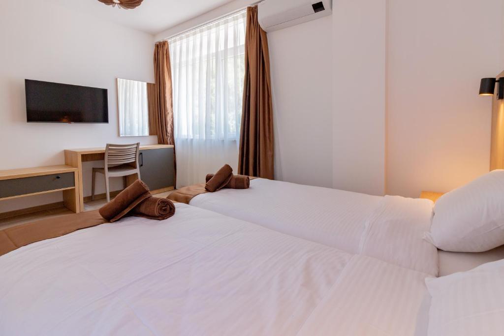 Postel nebo postele na pokoji v ubytování Lago Hotel