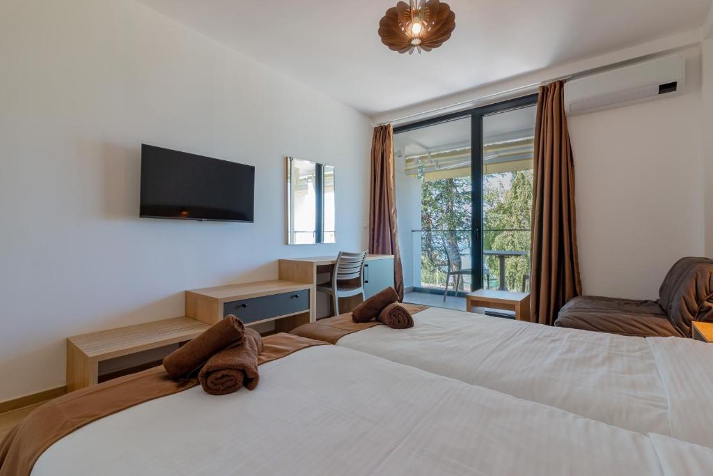 Postel nebo postele na pokoji v ubytování Lago Hotel