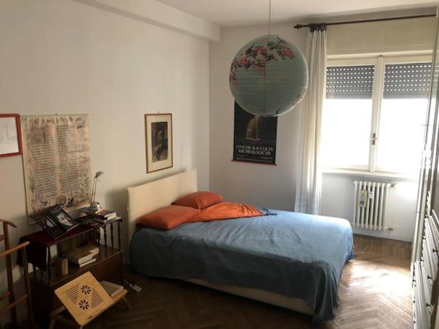 a bedroom with a bed and a balloon hanging from the wall at camera in via Tolstoi in Milan