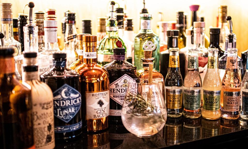 a bunch of bottles of alcohol on a table at Der Postwirt in Söll