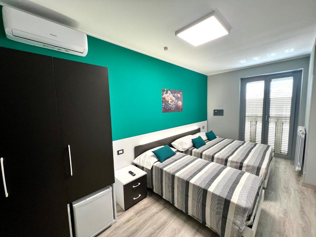 Postel nebo postele na pokoji v ubytování Siclari B&B-Rooms&Suite