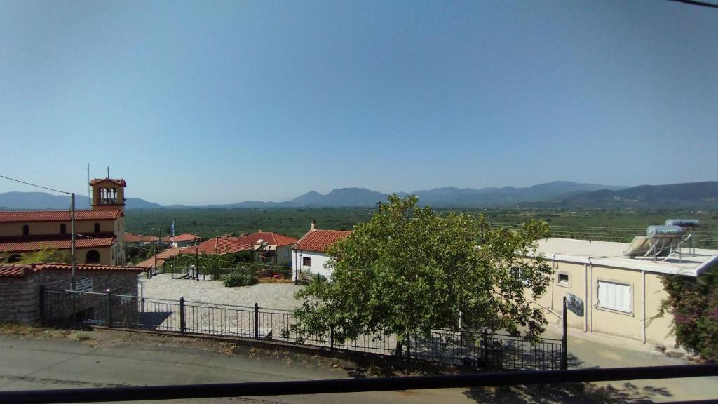 a view of a town with a building and a clock tower at Anastasia's House near Kalamata in Dhesíllas