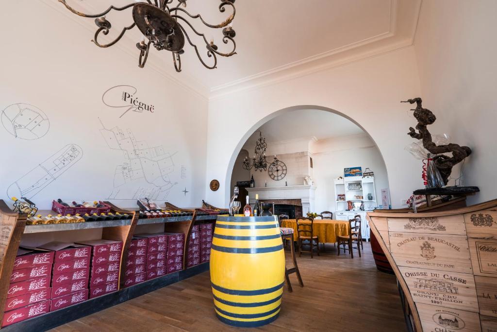 a store with a yellow and white barrel in a room at Vignoble Château Piéguë - winery in Rochefort-sur-Loire